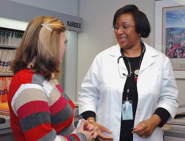 A woman and physician speaking to each other in an office.